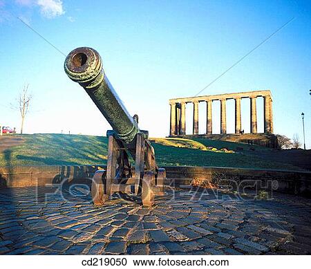 Stock Image - Old cannon and National Monument, replica of the Parthenon that was designed in 1822 as a memorial to the Scots who died in the Napoleonic Wars. Calton Hill, Edinburgh. Scotland. Fotosearch