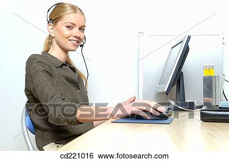 Stock Photograph - Operator working in office. Fotosearch