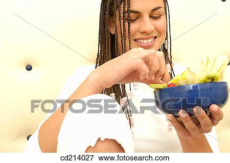 Woman eating fruit salad View Large Photo Image Stock Photo - Woman eating fruit salad. Fotosearch