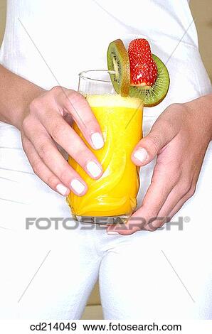 Woman holding orange juice, detail View Large Photo Image Stock Photo - Woman holding orange juice, detail. Fotosearch