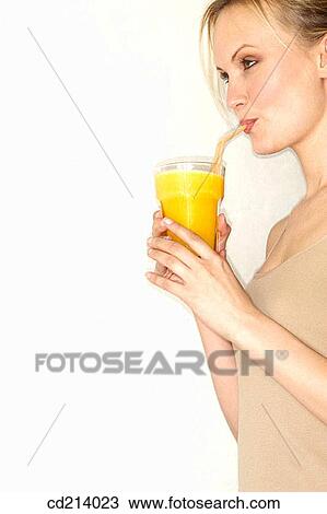Woman in-profile drinking orange juice View Large Photo Image Stock Image - Woman in-profile drinking orange juice. Fotosearch