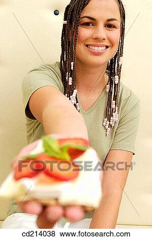 Stock Photo - Woman offering cheese toast. Fotosearch