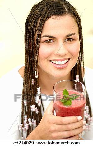Woman with plaits drinking juice View Large Photo Image Stock Photo - Woman with plaits drinking juice. Fotosearch