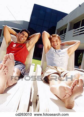 Stock Image - 30's, Best friend, beach chair, barefoot, 20's. Fotosearch
