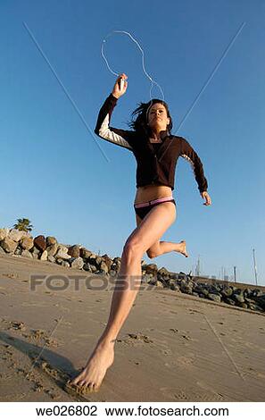 A woman running on the beach. View Large Photo Image Stock Image - A woman running on the beach.. Fotosearch
