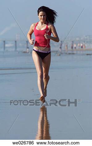A woman running on the beach. View Large Photo Image Stock Photograph - A woman running on the beach.. Fotosearch