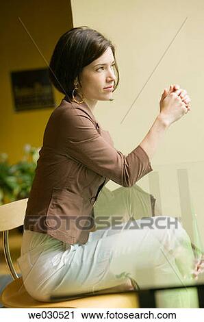 Stock Image - absorbed, brunette, 20's. Fotosearch