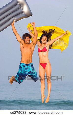 Stock Image - air-bed, beach, Arms raised, amusement, air mattress. Fotosearch