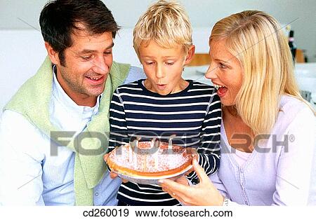 Stock Photo - at-home, blowing, blow, Birthday cake, 30's. Fotosearch