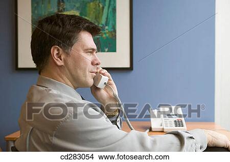 Picture - baby boomer, businesspeople, businessman, business, absorbed. Fotosearch