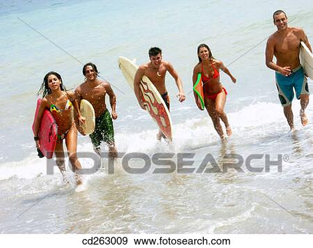 Stock Photo - beach, carry, boy, board, 20's. Fotosearch