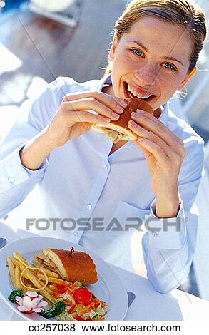 Stock Photo - bite, biting, blond, blue eyes. Fotosearch