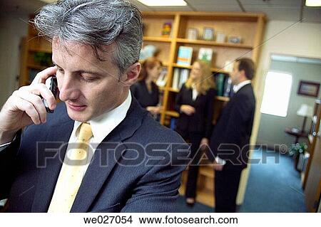 Picture - business, businessman, businesspeople, calling, cell phone. Fotosearch