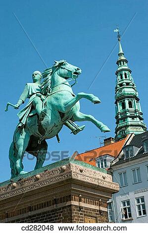 Equestrian statue of Bishop Absalon (1128-1201) in Hojbro Plads. Spire of Nikolaj Kirke background, Copenhagen, Denmark View Large Photo Image Stock Photo - Equestrian statue of Bishop Absalon (1128-1201) in Hojbro Plads. Spire of Nikolaj Kirke background, Copenhagen, Denmark. Fotosearch