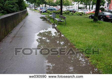 Large puddle on a street in Ratisbone / Regensburg, Upper Palatinate, Bavaria, Germany View Large Photo Image Stock Image - Large puddle on a street in Ratisbone / Regensburg, Upper Palatinate, Bavaria, Germany. Fotosearch