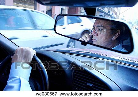 Man driving and using cell phone View Large Photo Image Stock Photo - Man driving and using cell phone. Fotosearch