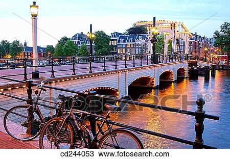 Stock Image - Skinny Bridge on Amstel canal. Amsterdam. Netherlands. Fotosearch
