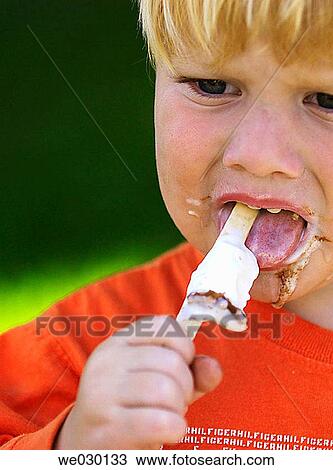 Stock Image - Toddler eating ice cream. Fotosearch
