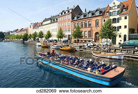 Tour boat on Christianshavns canal, Copenhagen, Denmark View Large Photo Image Stock Photo - Tour boat on Christianshavns canal, Copenhagen, Denmark. Fotosearch