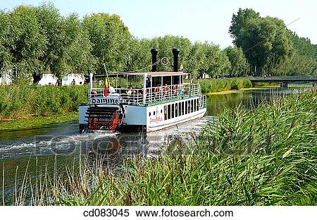 Tourist boat on canal to Damme, Brugge. Flanders, Belgium View Large Photo Image Stock Photography - Tourist boat on canal to Damme, Brugge. Flanders, Belgium. Fotosearch