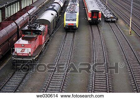 Trains in a railway station View Large Photo Image Picture - Trains in a railway station. Fotosearch