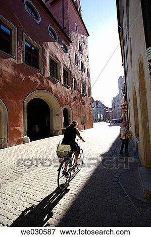 Woman cycling through medieval street (Waaggasse) in Ratisbone / Regensburg, Upper Palatinate, Bavaria, Germany View Large Photo Image Stock Photo - Woman cycling through medieval street (Waaggasse) in Ratisbone / Regensburg, Upper Palatinate, Bavaria, Germany. Fotosearch