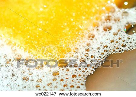 Stock Photo - Yellow sponge in dish-washing water. Fotosearch
