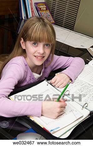 Stock Photo - 10 year old Caucasian girl doing homework. Fotosearch
