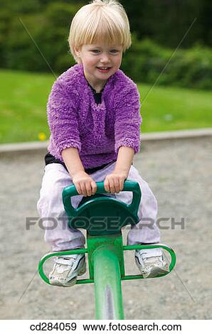 2. 5 year old girl on playground ride View Large Photo Image Stock Photo - 2. 5 year old girl on playground ride. Fotosearch