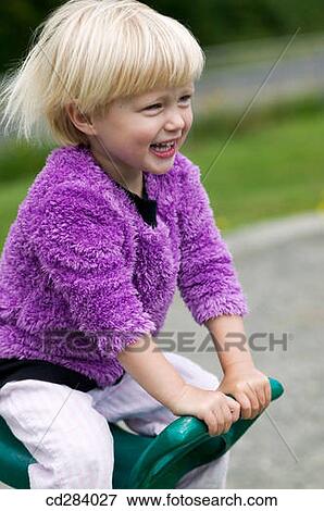 2. 5 yeard old girl on playground ride View Large Photo Image Stock Photo - 2. 5 yeard old girl on playground ride. Fotosearch