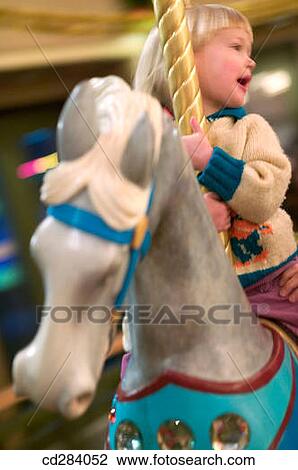 3 year old Caucasian girl on carousel horse View Large Photo Image Stock Image - 3 year old Caucasian girl on carousel horse. Fotosearch
