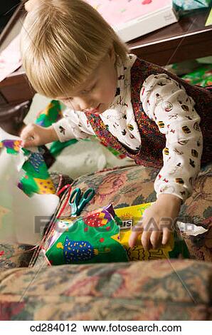3 year old girl opening presents View Large Photo Image Stock Image - 3 year old girl opening presents. Fotosearch