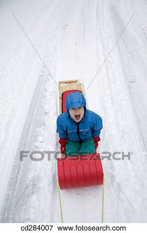3 year old on snow sled View Large Photo Image Stock Photo - 3 year old on snow sled. Fotosearch