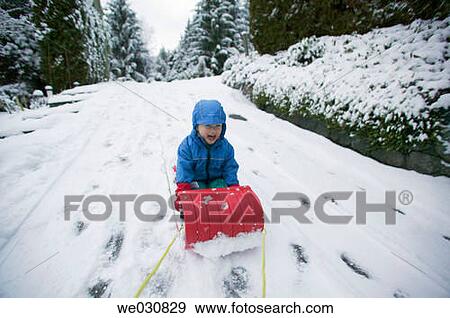 3 year old on snow sled View Large Photo Image Stock Photo - 3 year old on snow sled. Fotosearch