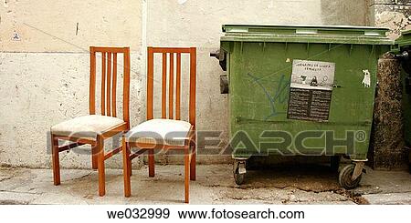 Stock Photo - Abandoned chairs by rubbish container. Fotosearch