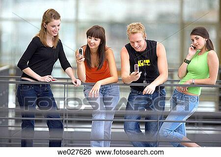 Stock Photograph - amusement, cell phone, boy, adolescence. Fotosearch