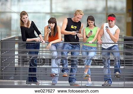 Stock Photo - amusement, college, cell phone, boy, adolescence. Fotosearch