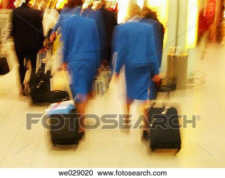 Stock Image - anonymous, blurred motion, baggage, back view, airport. Fotosearch