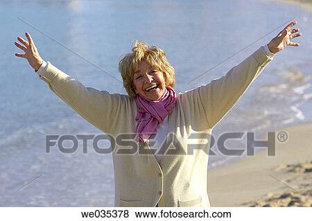 Arms raised, carefree, calm, beach, Arms open View Large Photo Image Stock Photo - Arms raised, carefree, calm, beach, Arms open. Fotosearch