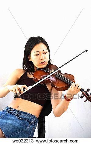 Asian/Chinese woman sitting playing violin View Large Photo Image Stock Image - Asian/Chinese woman sitting playing violin. Fotosearch