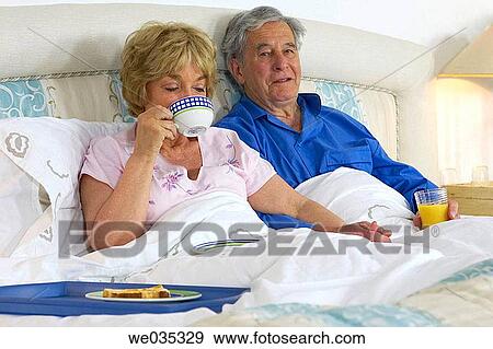Stock Photo - at-home, bond, bedroom, bed, affection. Fotosearch