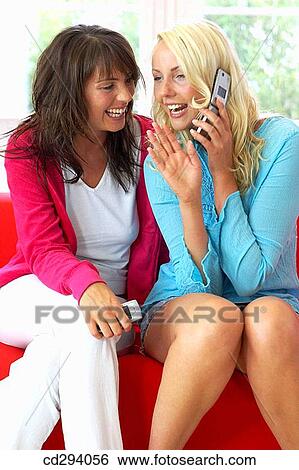 Stock Photograph - at-home, cell phone, calling, amusement. Fotosearch