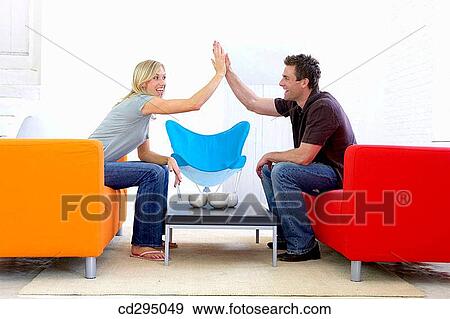 Stock Photo - at-home, companionship, Arms raised. Fotosearch
