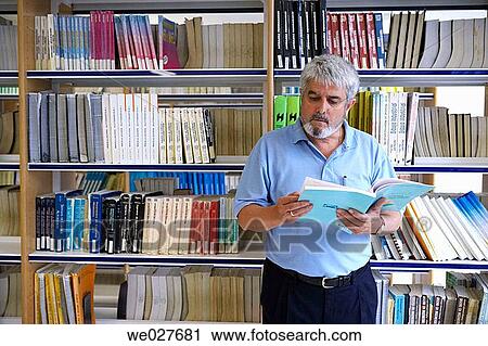 Stock Image - baby boomer, beard, bookcase, college. Fotosearch