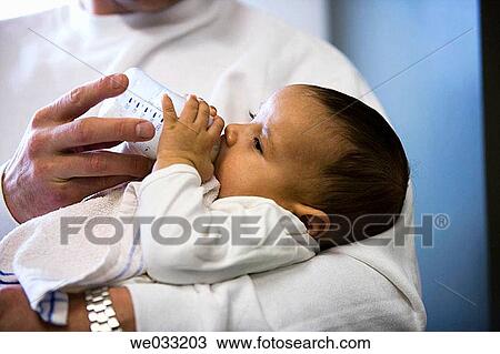 Baby gets bottle feeding. View Large Photo Image Stock Image - Baby gets bottle feeding.. Fotosearch