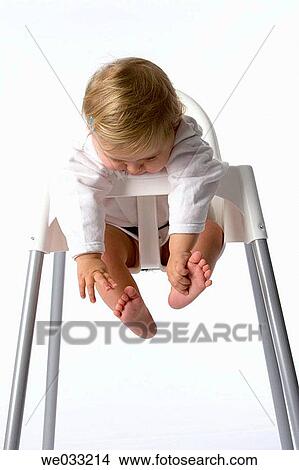 Baby girl in baby-chair. View Large Photo Image Picture - Baby girl in baby-chair.. Fotosearch
