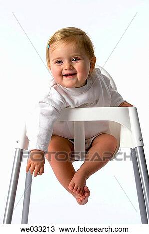 Stock Image - Baby girl in baby-chair.. Fotosearch