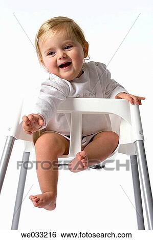 Baby girl in baby-chair. View Large Photo Image Stock Photograph - Baby girl in baby-chair.. Fotosearch