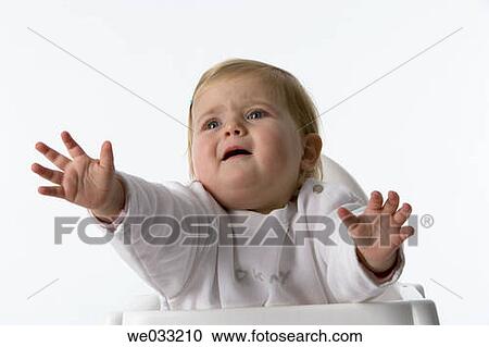 Stock Image - Baby girl reaching with her hands.. Fotosearch
