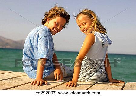 Stock Photo - back view, beach, boy, brother, child. Fotosearch